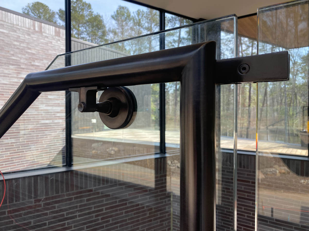 Bronze glass railing handrail and handrail brackets by fabricator Leo Gaev Metalworks Chapel Hill NC